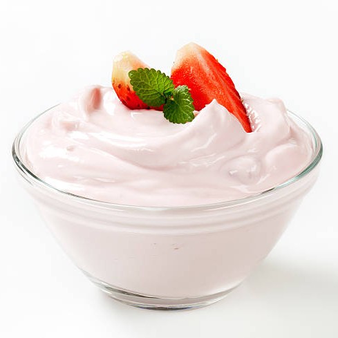 white cream with strawberries and mint in a small glass bowl
