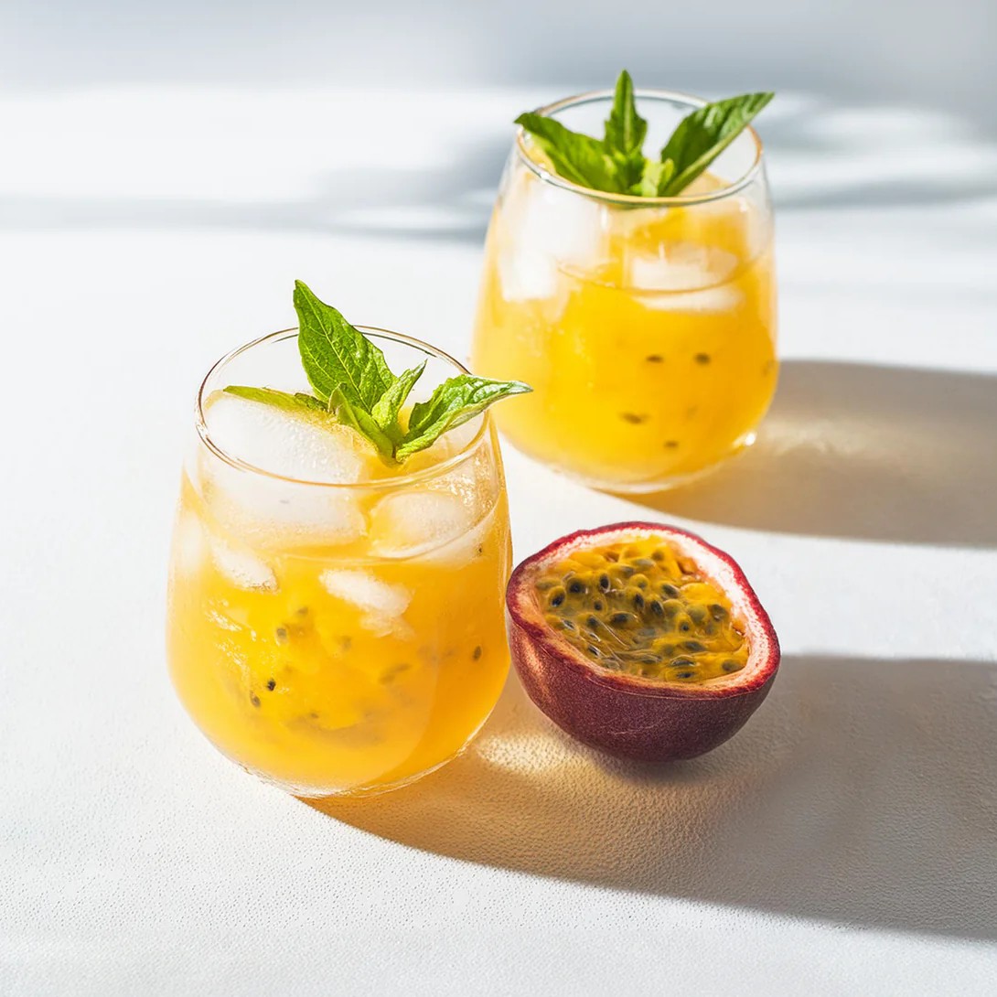 Firefly_passionfruit_juice_with_ic_e_and_garnished_with_mint_leaves_on_a_clean_white_surface_59402-Recovered
